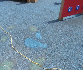 Playground surface hole repair.