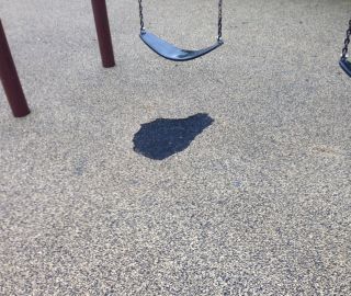 Fix holes in playground surface with poured in place repair kit.