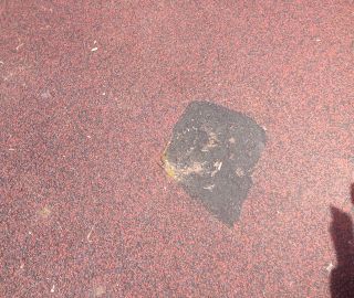 A hole like this should be repaired with our playground repair kits to avoid tripping.