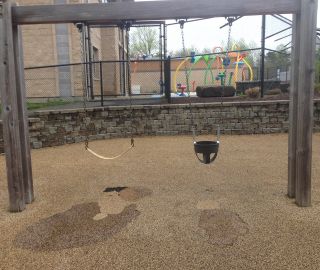Area under swings often need playground surface repair kits due to high traffic.