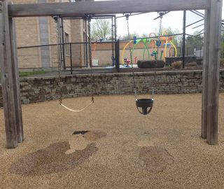 Area under swings often need playground surface repair kits due to high traffic.