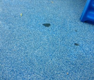 Poured rubber repair with playground surface repair kit.