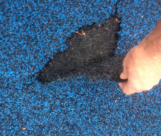 Damaged rubber surfacing should be patched and maintained to avoid tripping hazards.
